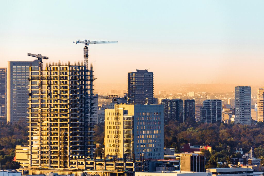 pexels photo 15937637 15937637 Aerial view of construction cranes and skyscrapers in Ciudad de México at sunset.